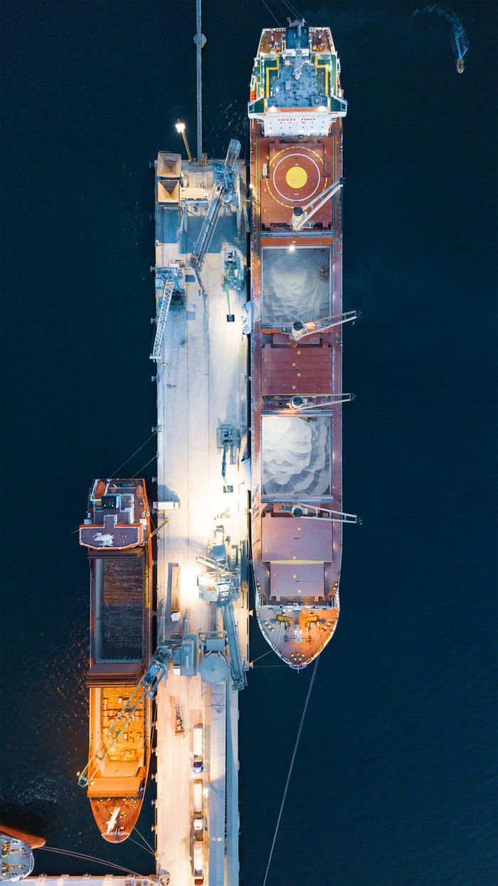 Services Aerial view of a container ship docked in Körfez, Kocaeli, Türkiye at night.